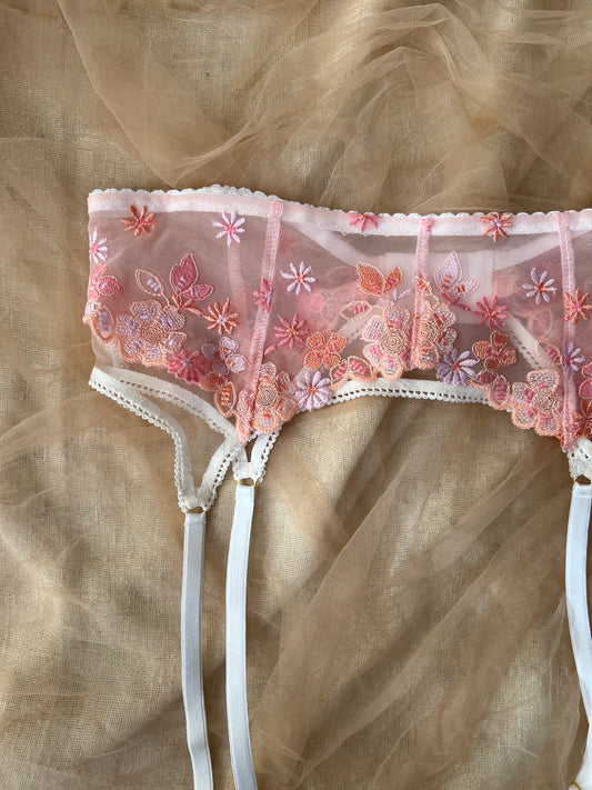 Lace lingerie with floral embroidery on a beige fabric background