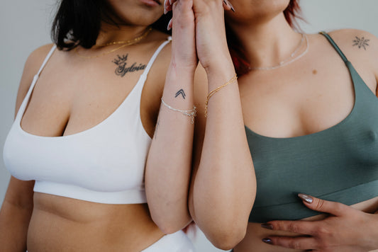 This image features two models showcasing a bamboo bralette in white and green colors. The bralette boasts a comfortable, pull-over design with no fussing over hooks and clips, emphasizing its ease of use.