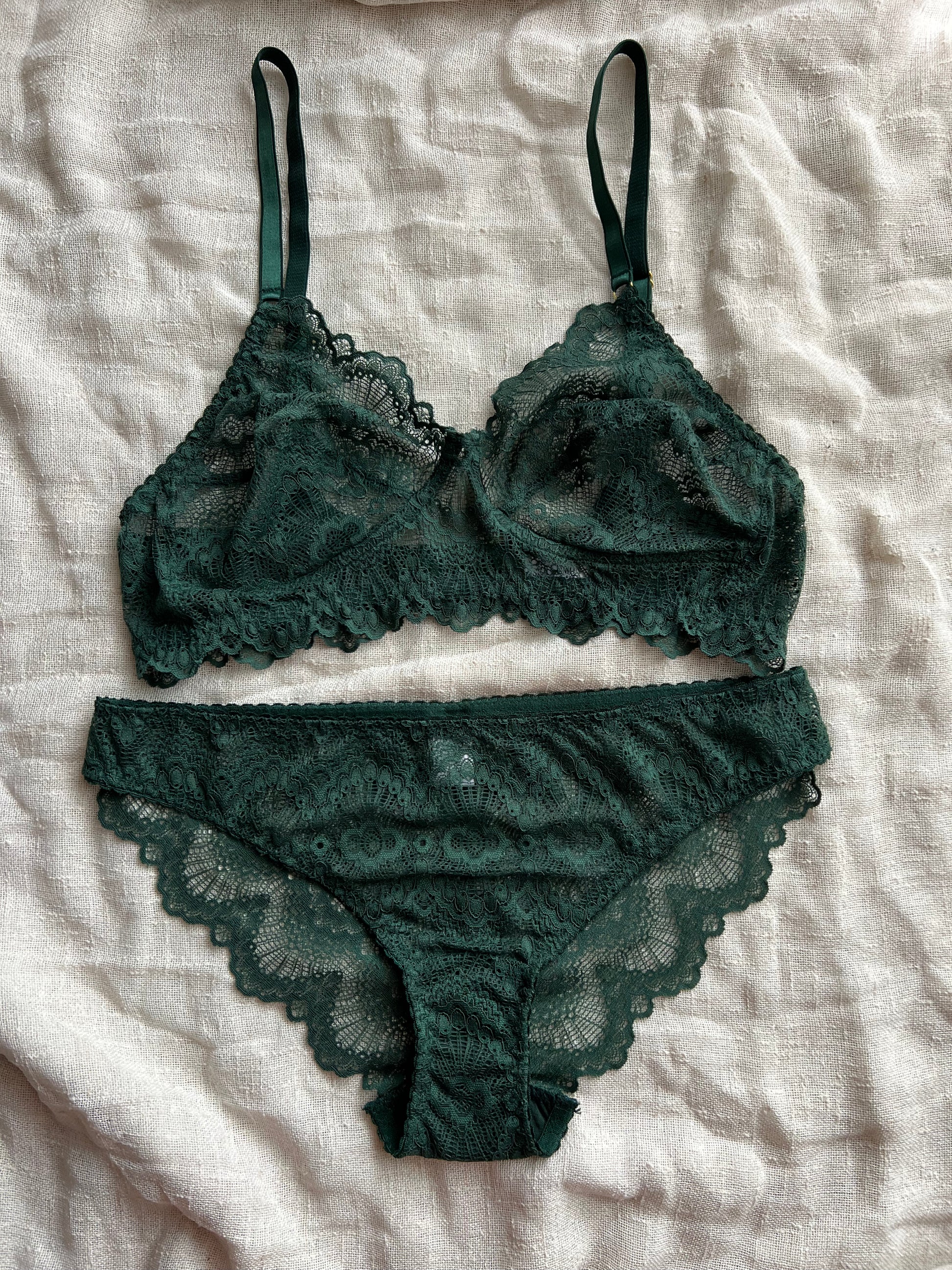 Green lace lingerie set on a light fabric background