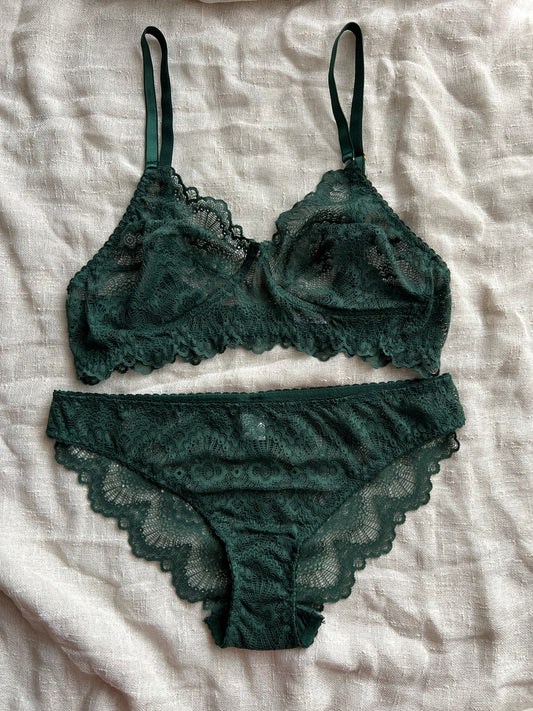 Green lace lingerie set on a light fabric background