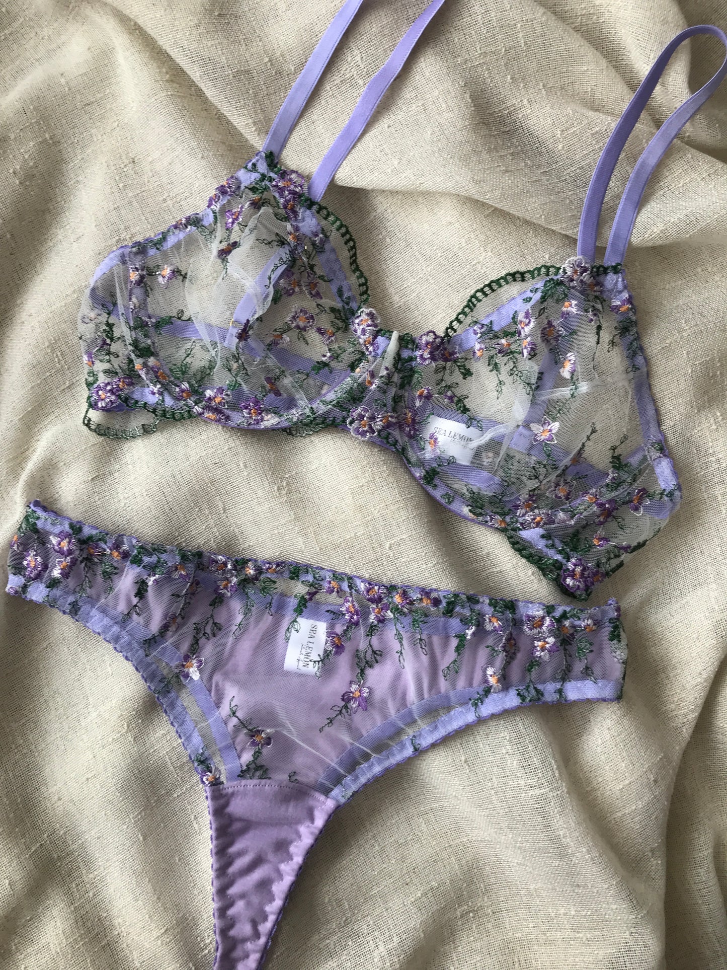 Floral lingerie set on a beige fabric background