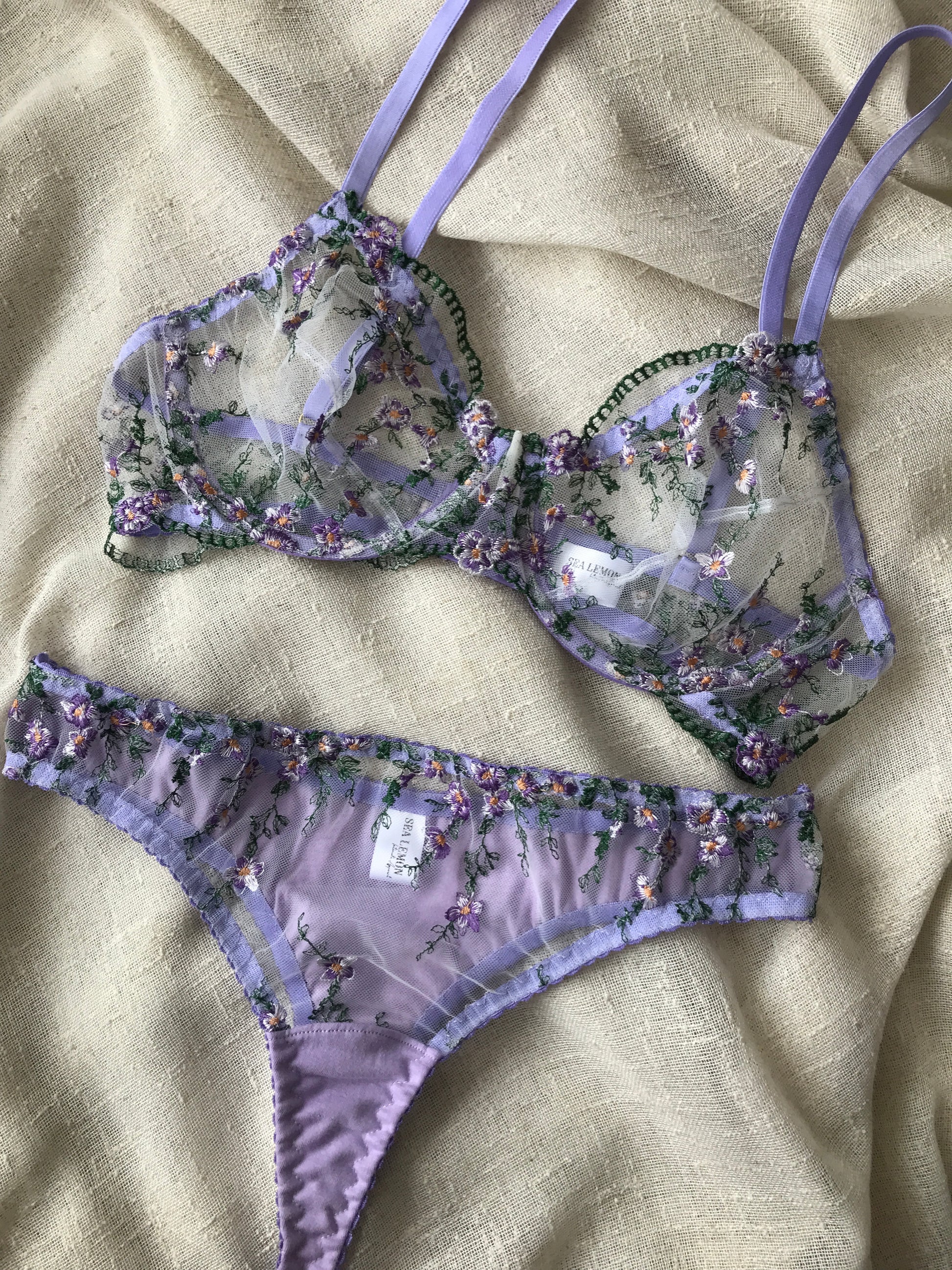 Floral lingerie set on a beige fabric background