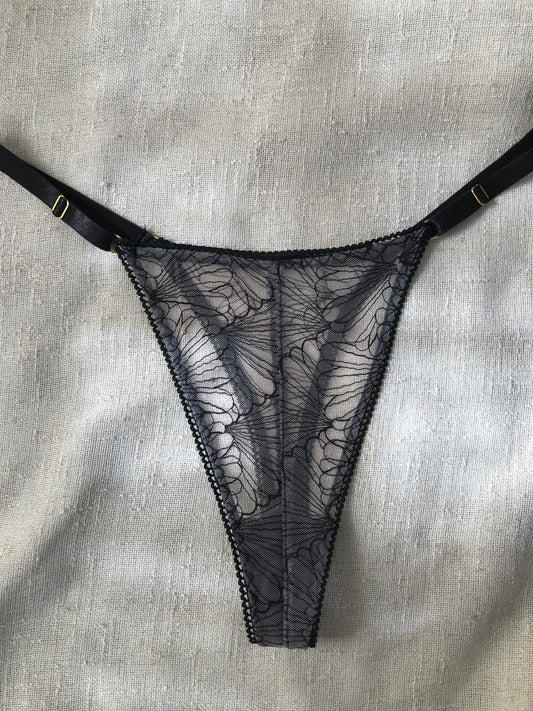 Black lace lingerie on a textured gray surface