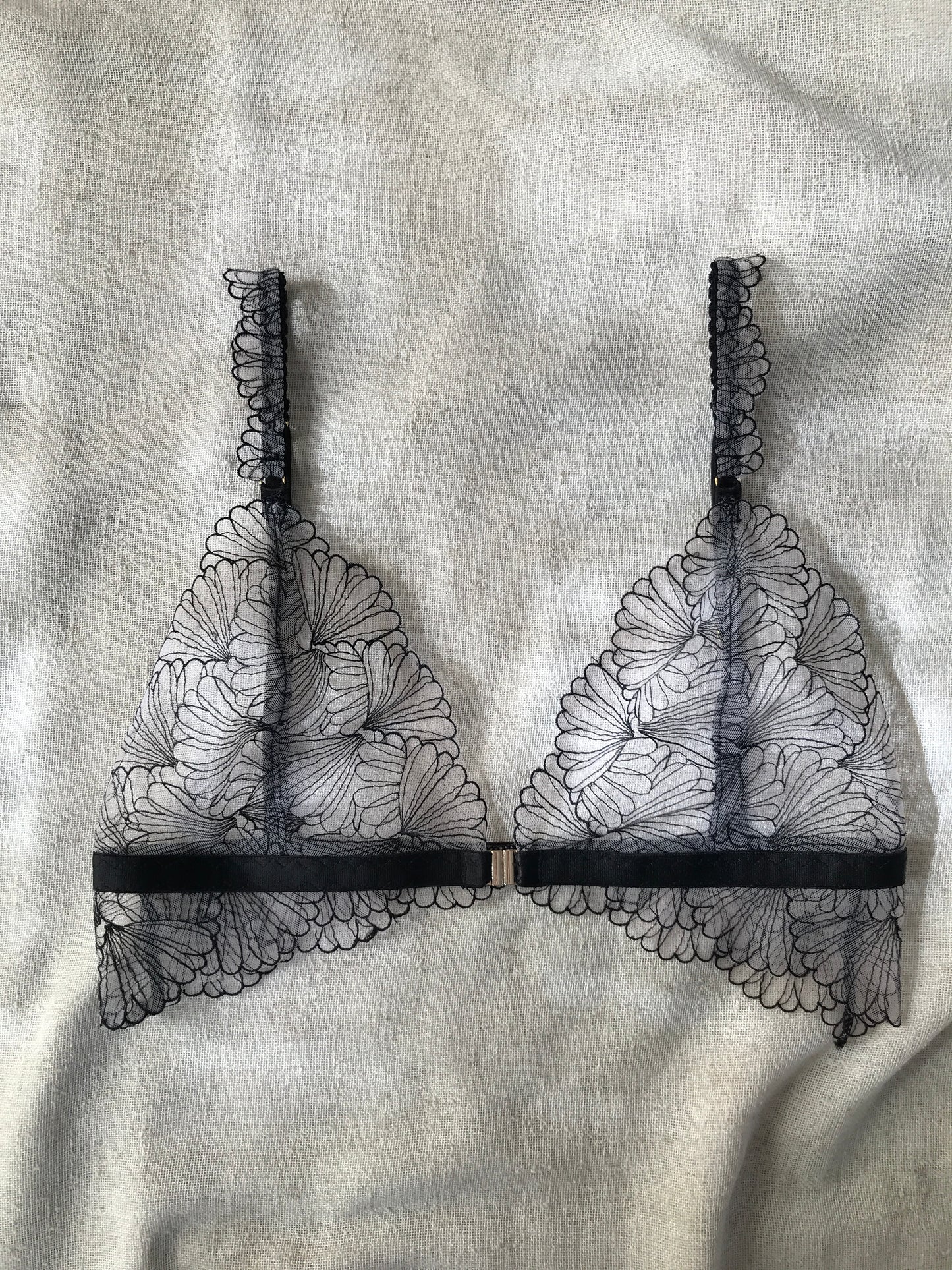 Black lace lingerie on a textured fabric background