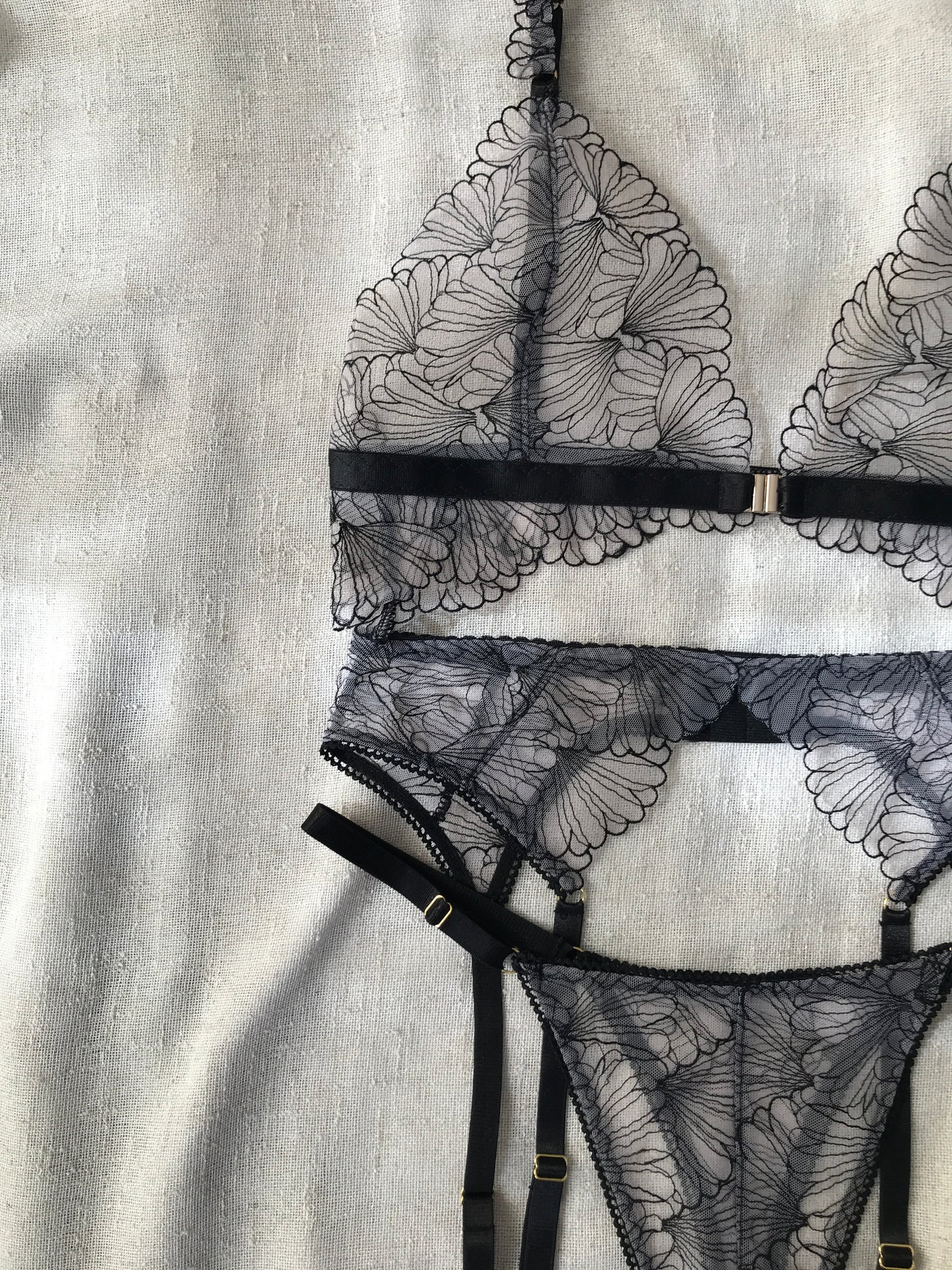 Black lace lingerie set on a textured gray background