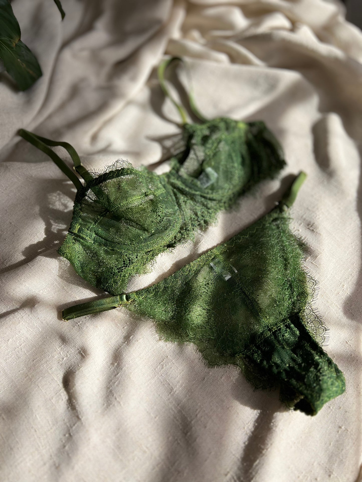 Green textured fabric on a beige fabric background